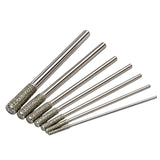 Six metal rotary burr bits with textured diamond-coated shanks, arranged diagonally on a plain white background.